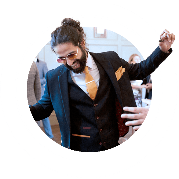 Man in suit dancing at wedding