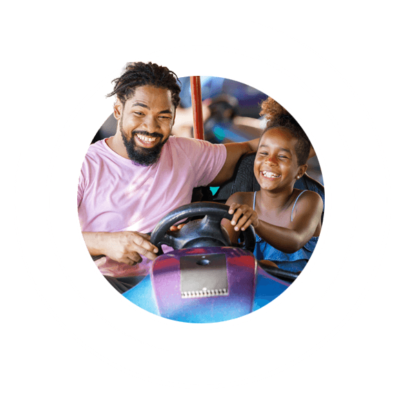 Dad and daughter riding bumper car